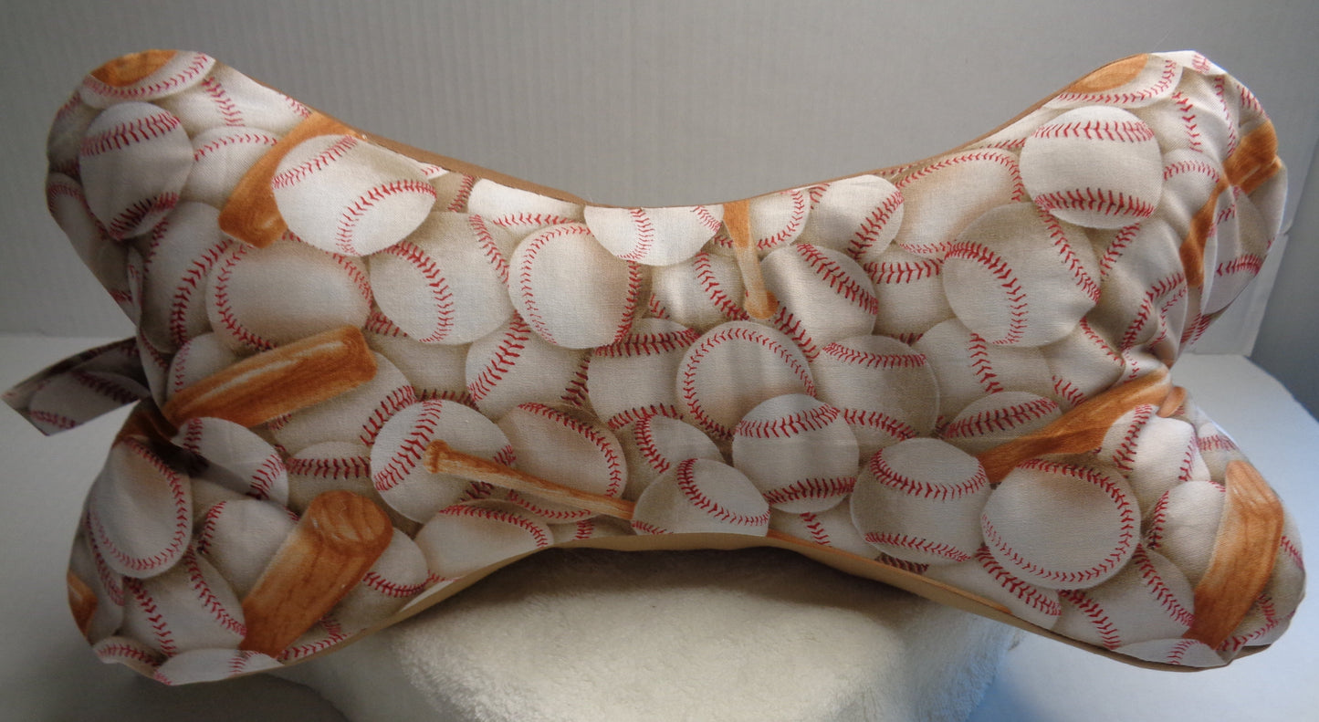 A bone-shaped fabric pillow with a baseball print. 