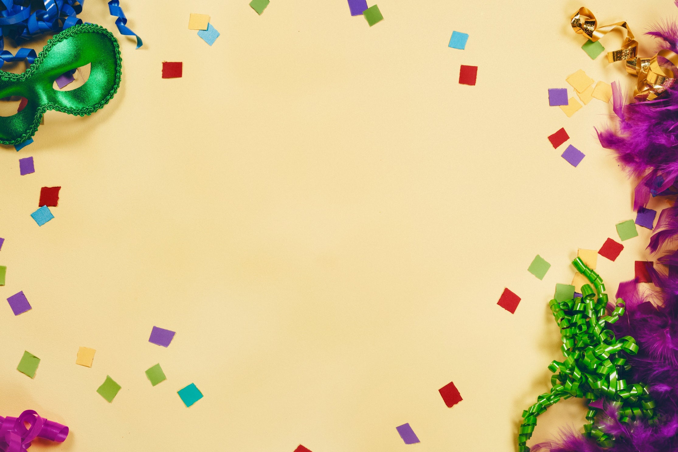 Colorful Mardi Gras masks and confetti on a beige background