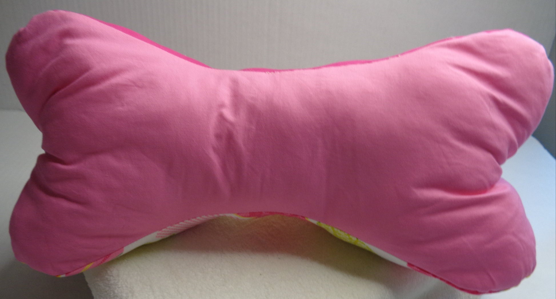 side three of the Heart Bone Pillow is a soft pink color. 
