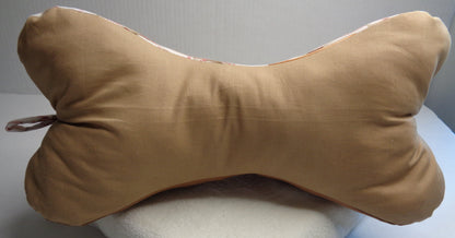 A bone-shaped neck pillow with a tan  fabric. Side three of the baseball pillow.